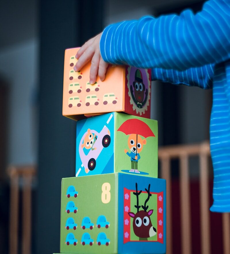child building an four boxes